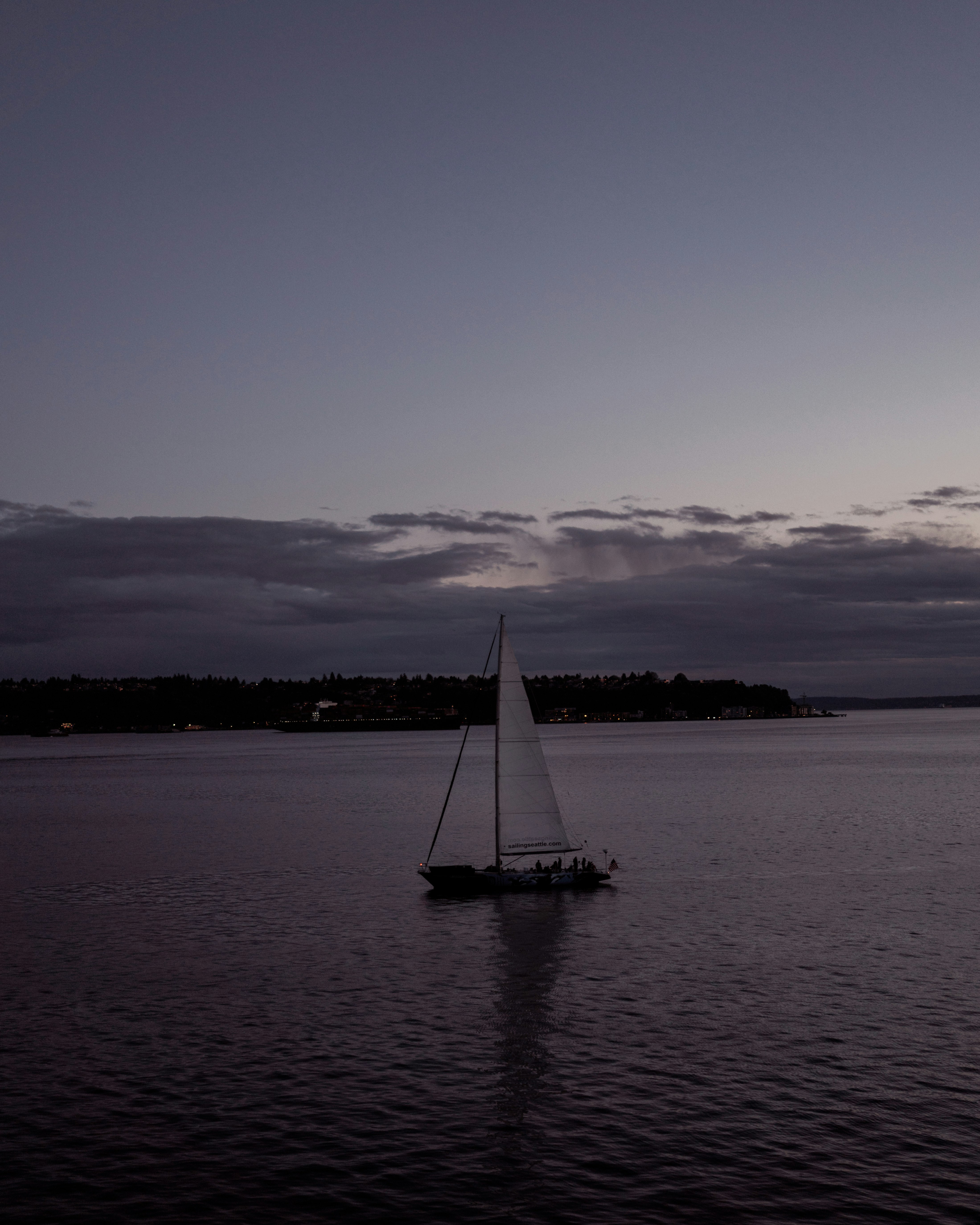 white sailboat on calm water during daytime